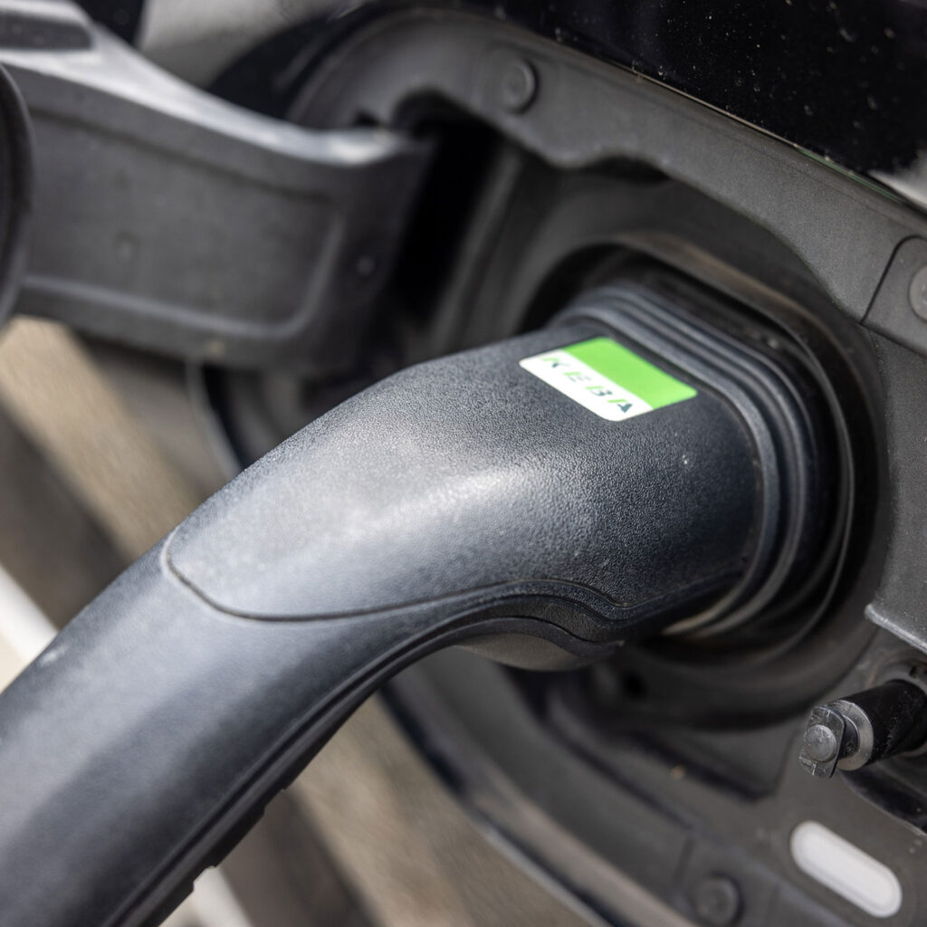 Eine Nahaufnahme einer angeschlossenen E-Auto Ladesäule.